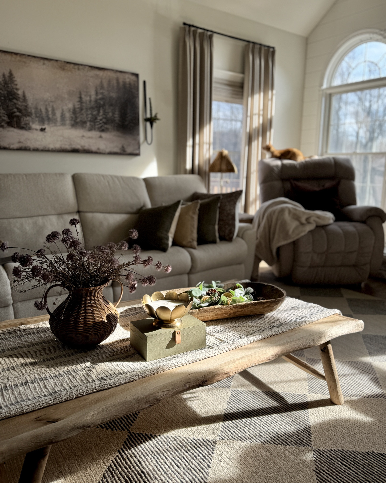 Current home vibes! Moody winter wall art, woven vase, wall candle sconces, scalloped brass candle, stacking tables, hanging brass bells, decorative fabric box, pillow inserts and pillow covers, custom reclaimed wood coffee table, curved arm floor lamp, charcoal and beige geometric rug, tall window pane mirrors, the poplar dusty plum stems, whimsical tree, white terracotta pots, and more! Neutral accent chair from Best Home Furnishings. 