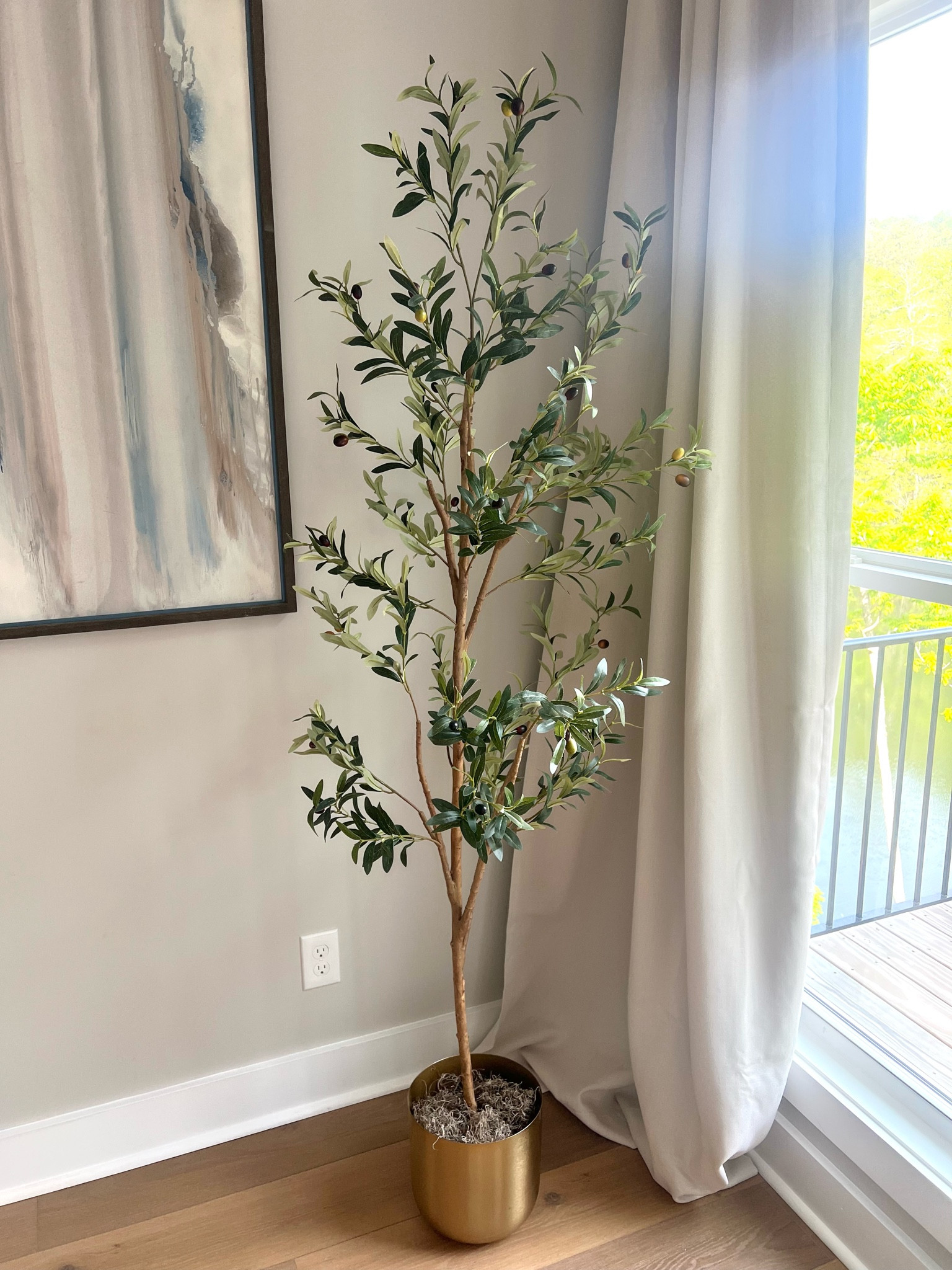 This faux olive tree from Walmart is everything! I got the 6ft. option and placed it inside this brass planter from Target. 

#LTKhome #LTKfindsunder100