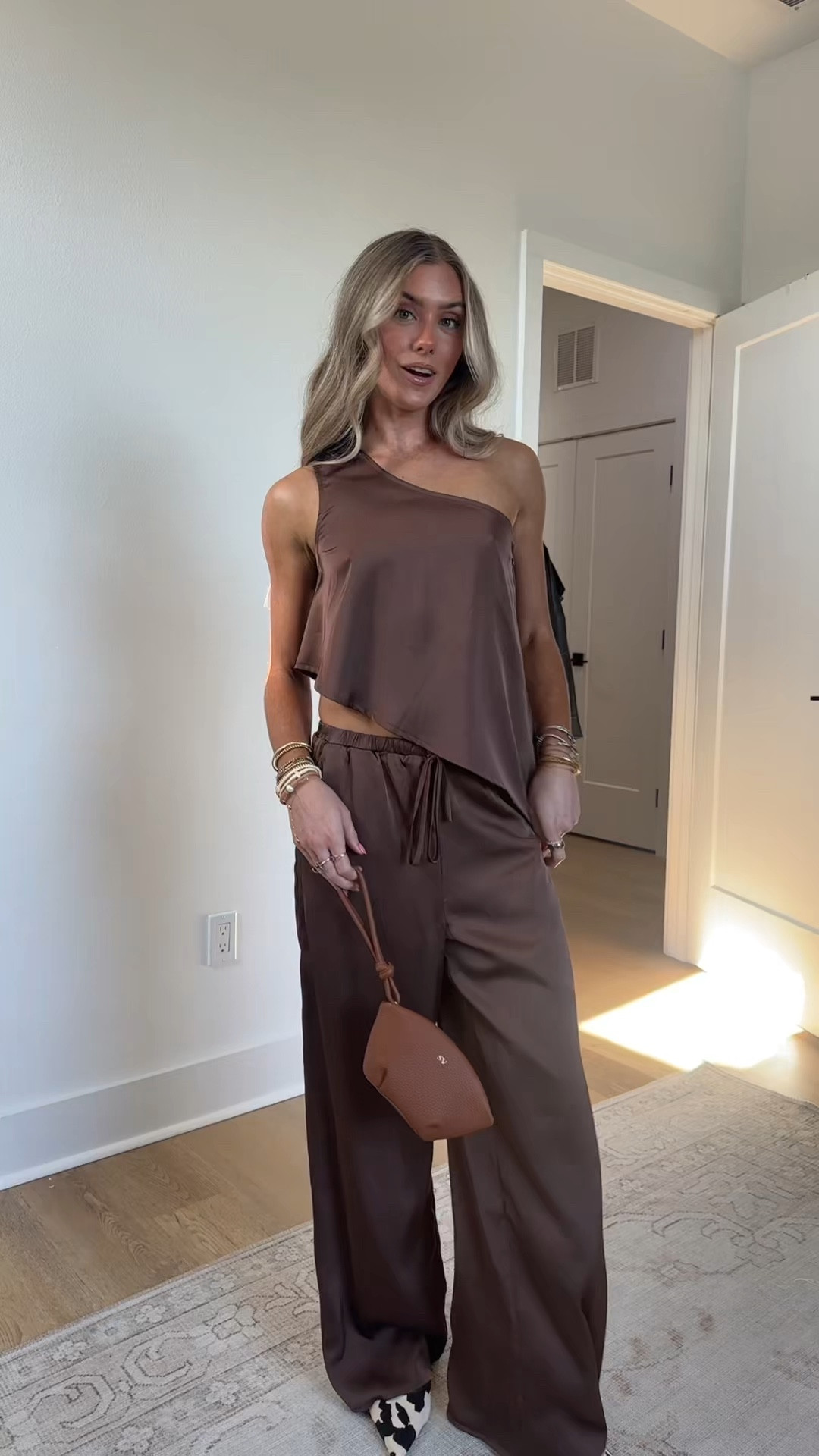 Outfit for the night! size XS pants and top my code is SLOANEV10. 
Chic never looked this easy. The Estelle Espresso Top with a one shoulder neckline and asymmetrical silhouette is made to move with you. Pair with the matching Estelle Espresso Pants for a head-turning set, or style solo with a tank or tee for elevated off-duty vibes. Chic never looked this easy. The Estelle Satin Pant flows with a wide-leg silhouette in rich espresso satin—made to move with you.Pair it with the matching Estelle Espresso One Shoulder Top for a head-turning set, or style solo with a tank or tee for elevated off-duty vibes  @12th Tribe  my bag is @Leatherology 

#LTKootd #LTKSeasonal #LTKSaleAlert