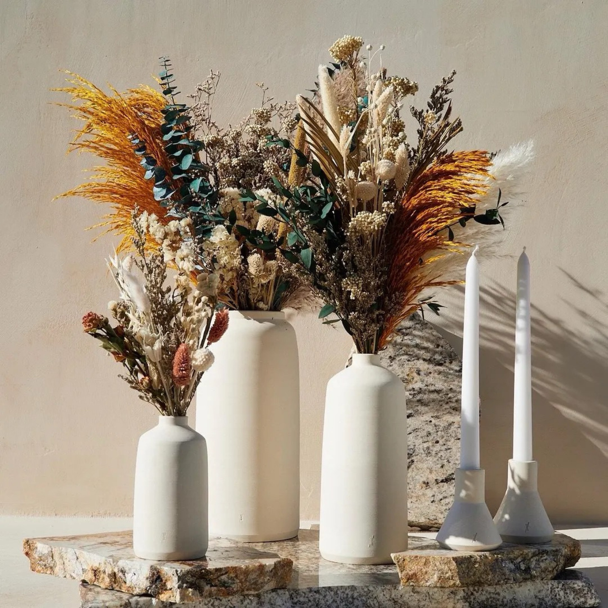 Soft, neutral tones meet rich texture in this long-lasting dried bouquet, featuring pampas grass, limonium, dried roses, pearl millet, eucalyptus, bunny tails, palm leaf, oats, and more. Designed in a calming palette of gray, off-white, brown, and warm orange, it blends seamlessly into any space while adding depth and natural elegance. Each arrangement is handcrafted and made to last over a year, making it a timeless piece for everyday styling or seasonal refreshes. #ltkhome #ltkdecor #driedflowers #neutraldecor #pampasgrass #bohodecor #homestyling #cozyhome #sustainabledecor

#LTKHome #LTKSeasonal #LTKWedding