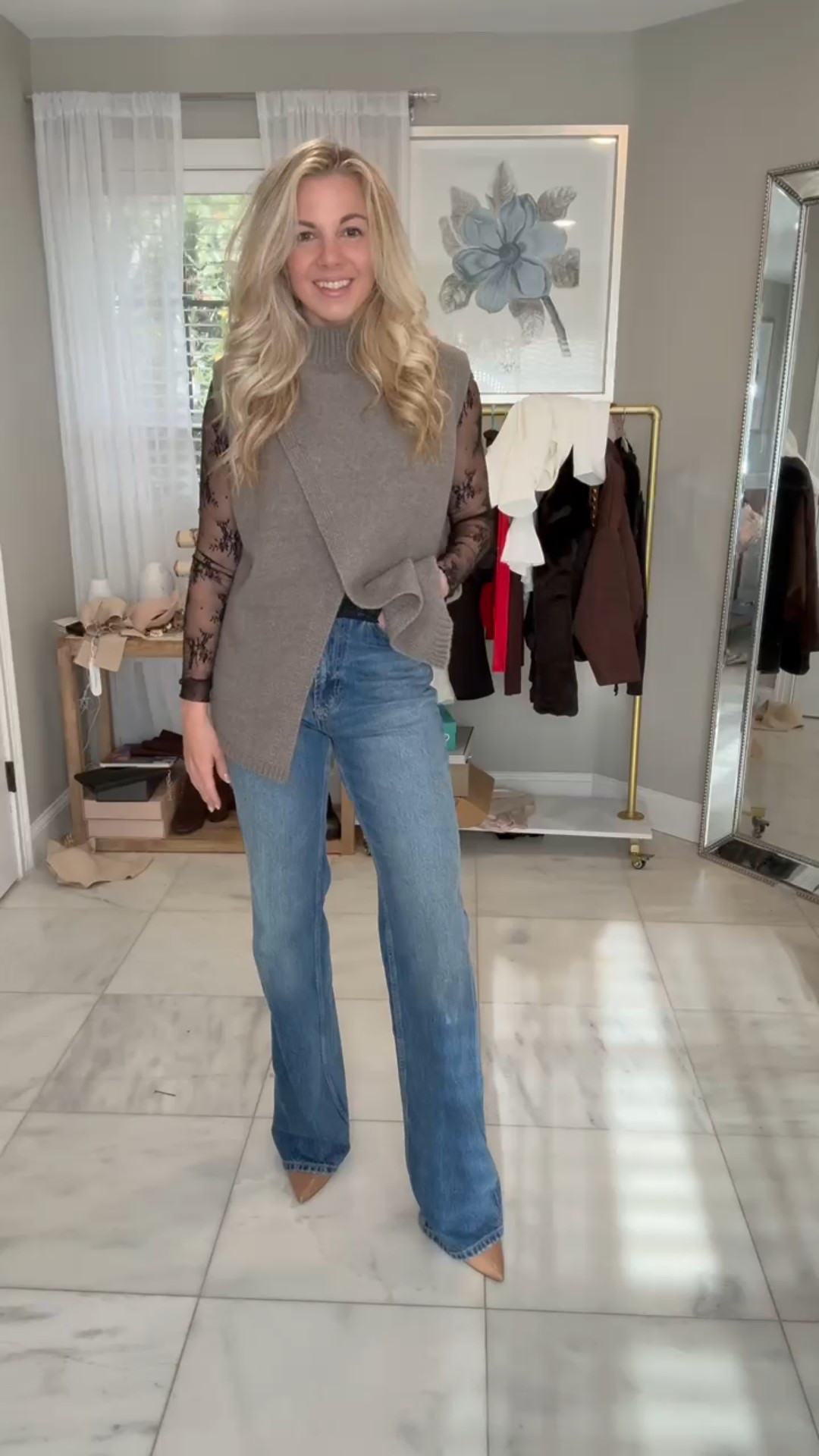 I have never seen anything like this mock neck sleeveless sweater top before ! This is soooo cute and perfect for layering on top of any long sleeve top for some extra warmth !! Obsessed with the criss-cross opening at the bottom so you could even tuck one side into your jeans ! 

#LTKHoliday #LTKU #LTKSeasonal