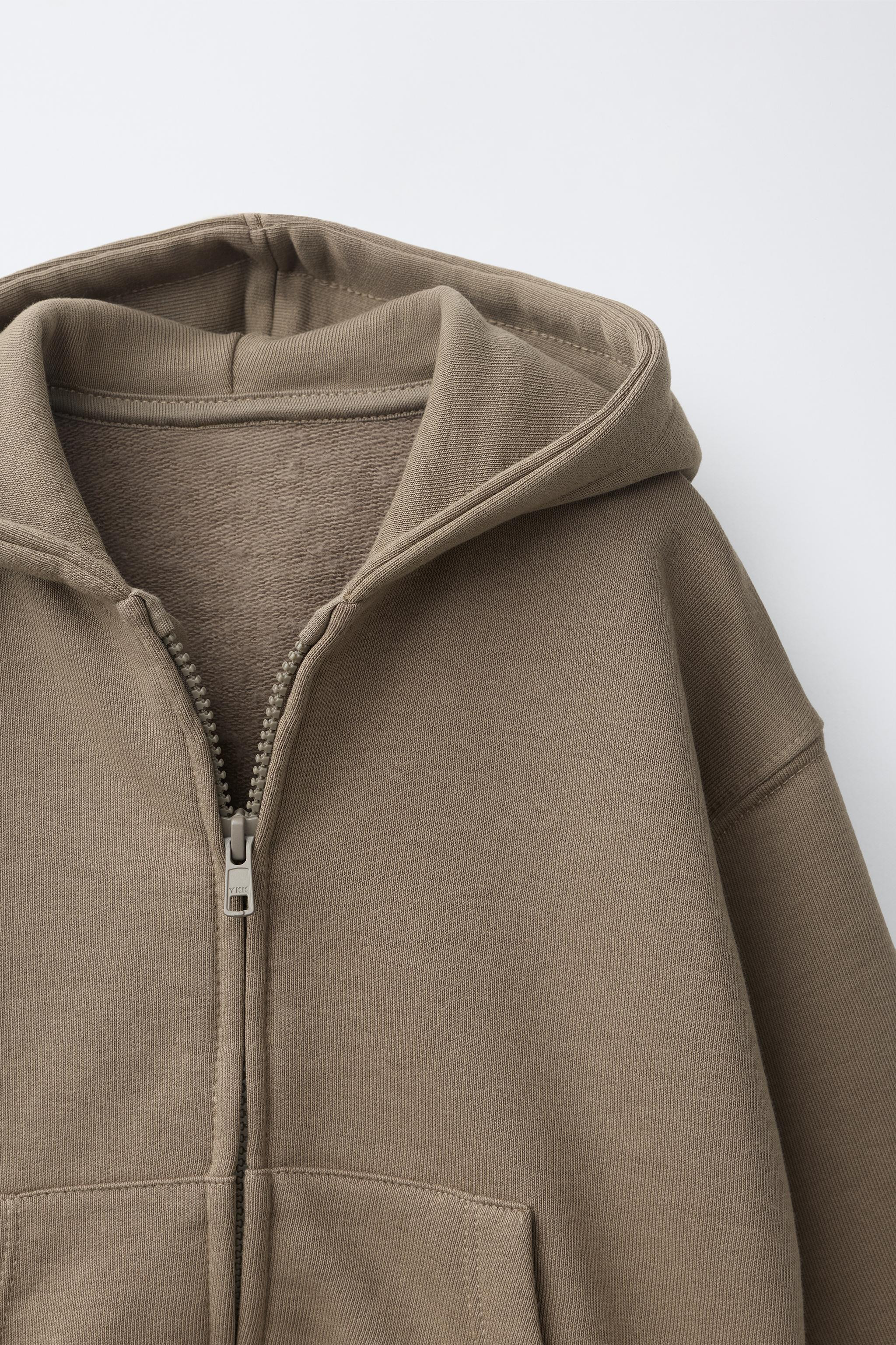 Long sleeve hooded sweatshirt. Ribbed trim. Front zip closure. Front patch pockets. Appliqu\u00e9... | Zara US