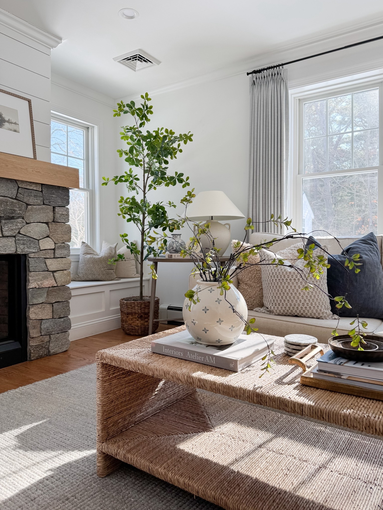 Bright neutral living room with woven coffee table, ceramic vase with greenery branches, linen drapery panels, and soft textured pillows. Natural light, organic materials, and warm wood tones bring a relaxed coastal feel. 
woven coffee table, neutral coastal decor, linen curtains, living room inspiration, spring home refresh, natural textures, ceramic vase decor, greenery stems, light filled living room, warm wood tones, coastal style, organic modern, sherri calnan home

#LTKHome