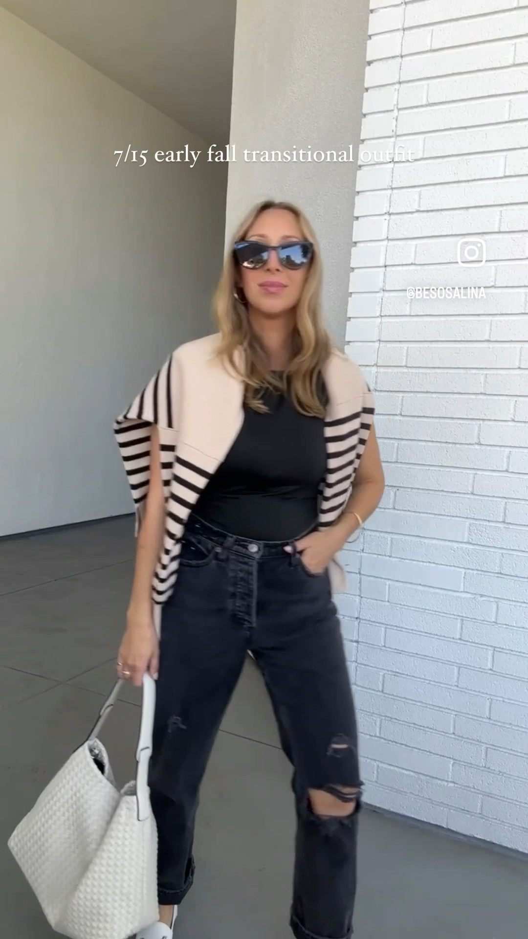 Early fall go to outfit with jeans and loafer cream details with black outfit striped sweater and new woven boho style bag tote 