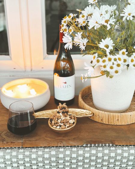 #ad Lowe’s (@LowesHomeImprovement) Spring Outdoor entertaining favorites for my patio console! I love this brass bee dish, citronella candle, faux daisies, rose colored stemless wine glasses and woven tray. Perfect for all backyard entertaining!☀️ #lowespartner  #loweshomeimprovement #backyardpatio #patio #entertaining #spring

#LTKstyletip #LTKhome #LTKSeasonal