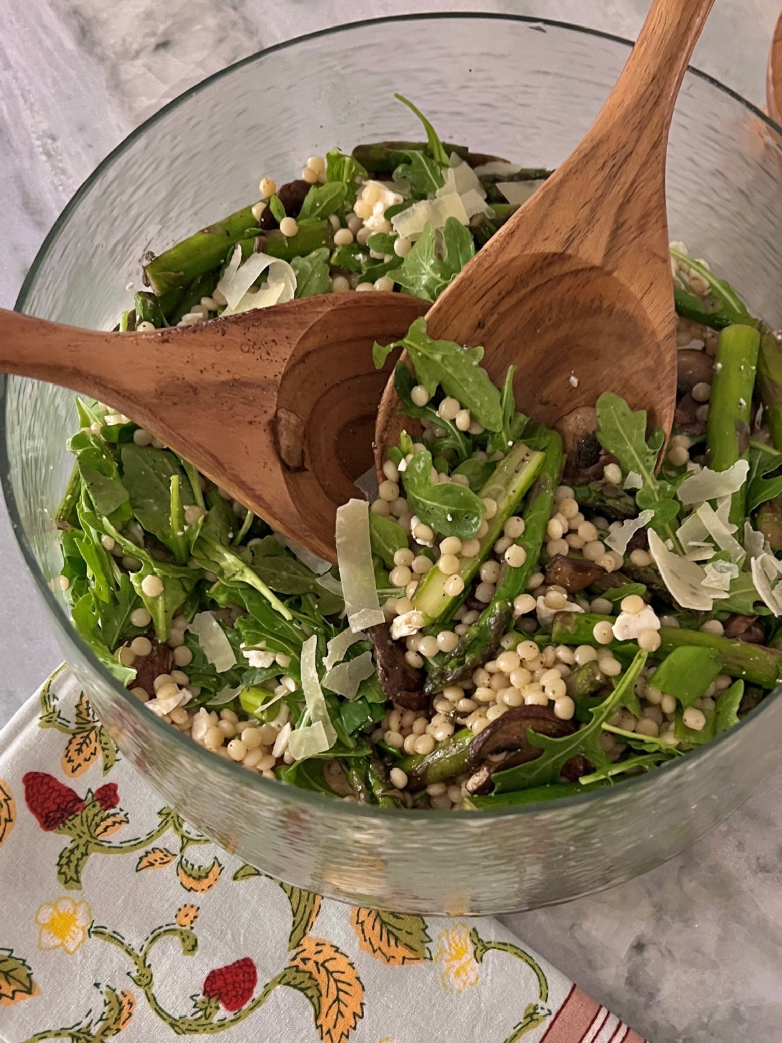 Acquired a new salad bowl and servers! Perfect for summer entertaining! 

Couscous Salad recipe: 

Israeli Couscous Salad with Mushrooms, Asparagus & Feta

Serves 6–8

Ingredients

Salad

* 1½ cups Israeli (pearl) couscous
* 2 tablespoons olive oil, divided
* 8 ounces cremini or baby bella mushrooms, sliced
* 1 bunch asparagus, trimmed and cut into 1-inch pieces
* 3 scallions, thinly sliced
* 2 cloves garlic, minced
* 4 cups baby arugula
* ¾ cup crumbled feta cheese
* ⅓ cup slivered almonds, toasted
* Kosher salt and freshly ground black pepper

Red Wine Vinaigrette

* ¼ cup red wine vinegar
* ½ cup extra-virgin olive oil
* 1 teaspoon Dijon mustard
* 1 teaspoon honey
* ½ teaspoon kosher salt
* ¼ teaspoon black pepper

Instructions

1. Cook the Couscous

Bring a large pot of salted water to a boil. Add the Israeli couscous and cook according to package directions (usually 8–10 minutes) until tender.

Drain and spread onto a baking sheet or large platter to cool slightly.

2. Sauté the Vegetables

Heat 1 tablespoon olive oil in a large skillet over medium-high heat.

Add mushrooms and cook until golden and their moisture has evaporated, about 5–7 minutes.

Add the remaining tablespoon olive oil, asparagus, scallions, and garlic. Sauté 3–4 minutes until asparagus is crisp-tender.

Season with salt and pepper.

Remove from heat and let cool slightly.

3. Make the Vinaigrette

Whisk together:

* Red wine vinegar
* Olive oil
* Dijon mustard
* Honey
* Salt
* Pepper

4. Assemble the Salad

In a large serving bowl combine:

* Cooked couscous
* Mushroom and asparagus mixture
* Arugula

Pour about three-quarters of the vinaigrette over the salad and toss gently.

Fold in:

* Feta cheese
* Toasted almonds

Taste and add additional vinaigrette, salt, and pepper as needed.