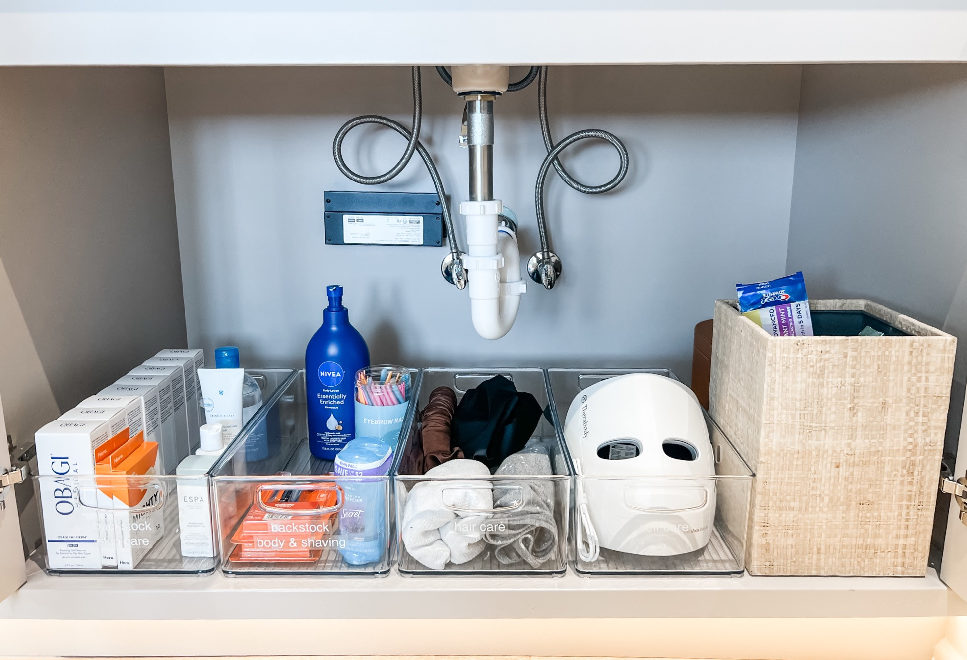 Don't let the red-light therapy mask jumpscare you - this is just a beautifully organized under-sink space! 

 