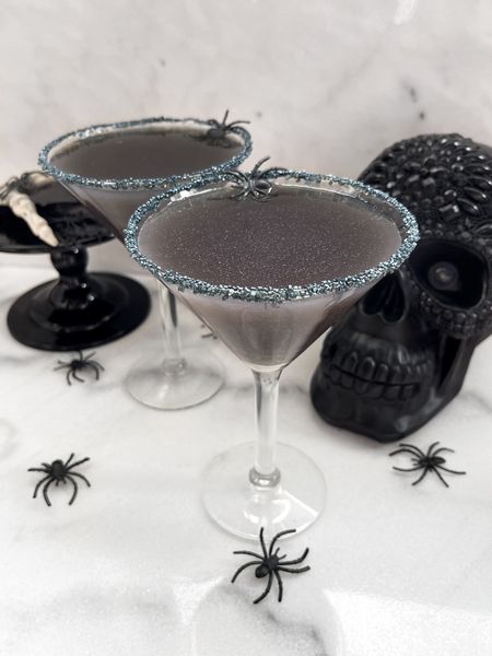 Black Magic Martini 

Ingredients:
¾ oz black vodka
½ oz Chambord
1½ oz cranberry juice
½ oz lemon juice
Glitter/shimmer drink mix amount according to package directions. 

Directions:
Add ingredients into shaker with ice and shake till chilled. Rim martini glasses with glitter sprinkles. Pour drink from shaker into martini glasses. Serve and enjoy!

#halloweendrinks #halloweendrinkrecipe #halloweendrinkrecipes #recipes #halloweenrecipes #halloweenmartini #entertaining #halloweenparty #martiniglasses #blackmartini
#LTKseasonal



#LTKfindsunder50 #LTKHalloween #LTKhome