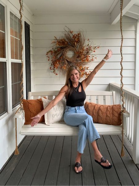 Some fun fall decor for your porch including grapevine wreath, fall stems, fall pillows, porch swing, Levi jeans, black tank, Tory Burch sandals and more.

#LTKSeasonal #LTKHoliday #LTKhome