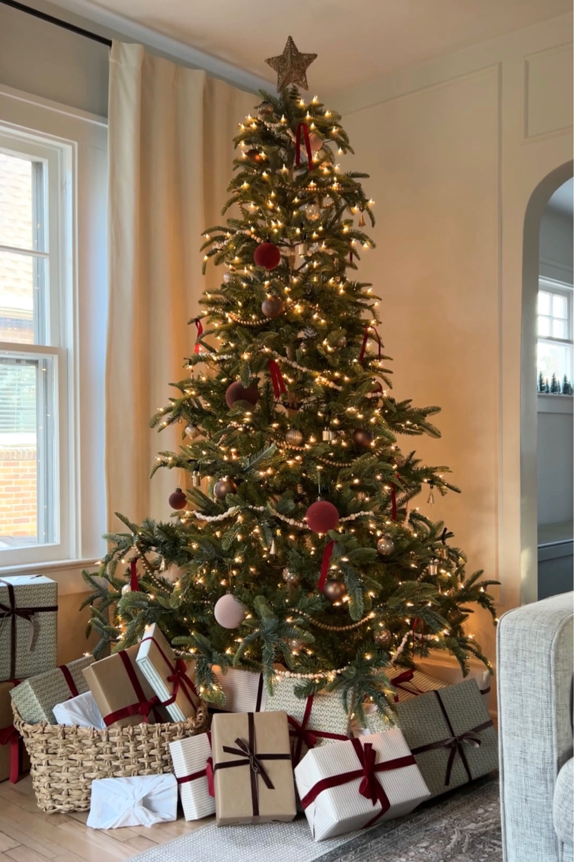 Christmas tree with bead garland, velvet ornaments, brass bells, velvet ribbon, and a woven star tree topper. #christmasornaments #christmastree 

#LTKHoliday #LTKHolidaySale #LTKSeasonal