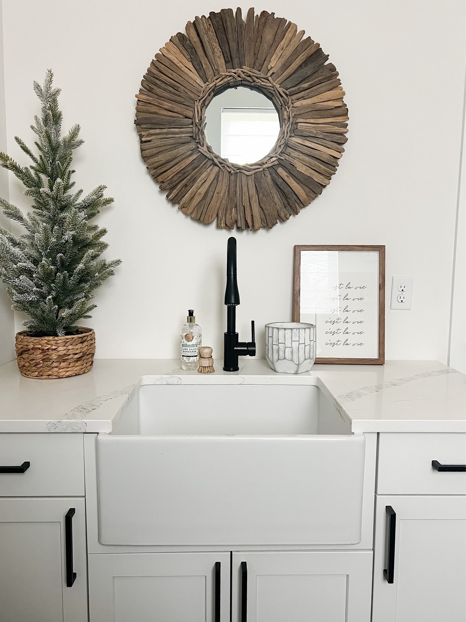 cozy winter moment in the utility room ✨🌲
Loving how the natural wood mirror, frosted tree, and black hardware warm up this bright white space. Simple styling that feels clean, fresh, and perfect for the season.
Tap to shop the mirror, faucet, tree, soap, sink accessories, and countertop decor 🤍#UtilityRoomDecor #LaundryRoomDecor #NeutralHomeDecor #OrganicModernHome #ModernFarmhouseStyle #WinterHomeDecor #SinkStyling #CozyHomeInspo #HomeDecorFinds 


#LTKHome #LTKHoliday #LTKSaleAlert