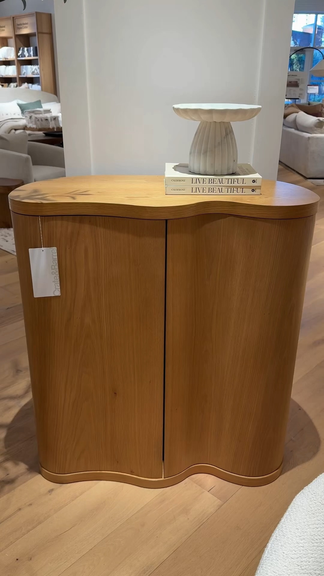 Chic bar cabinet moment! 🍾 The Winslow Natural Oak Wood Bar Cabinet from Crate & Barrel is such a standout with its sculptural curves and contemporary asymmetrical design. 🤎 Crafted from solid oak, the natural knots and grain give it so much warmth and character. 😍 Push-open doors reveal a beautiful olive green interior with plenty of storage, including pivot drawers and multiple shelves designed to follow the cabinet’s flowing shape. ✨ A stylish statement piece for storing bar essentials while adding modern organic style to your space. Linked this cabinet and other similar styles to shop!🥂#CrateAndBarrel #BarCabinet #BarInspo

#LTKHome #LTKSaleAlert