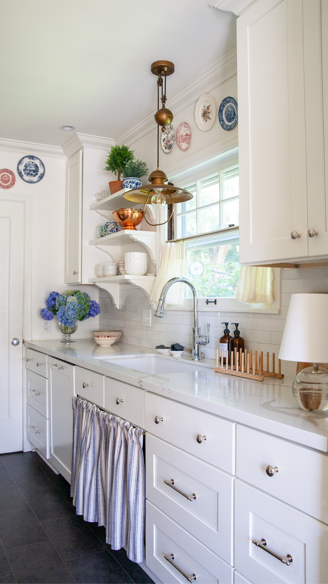 I’ve been working on some updates to this kitchen I renovated in 2019–it was a plain white kitchen back then which, it turns out, is boring but a flexible backdrop for several different styles. By swapping brushed brass for polished nickel and industrial metal for traditional painted wood, and a few other styling changes, I was able to lean into the Nancy Meyers kitchen vibes we all want these days—which hopefully is timeless since we love her kitchens from the early 2000s too! Proof you can transform a kitchen with a few surface level changes!!