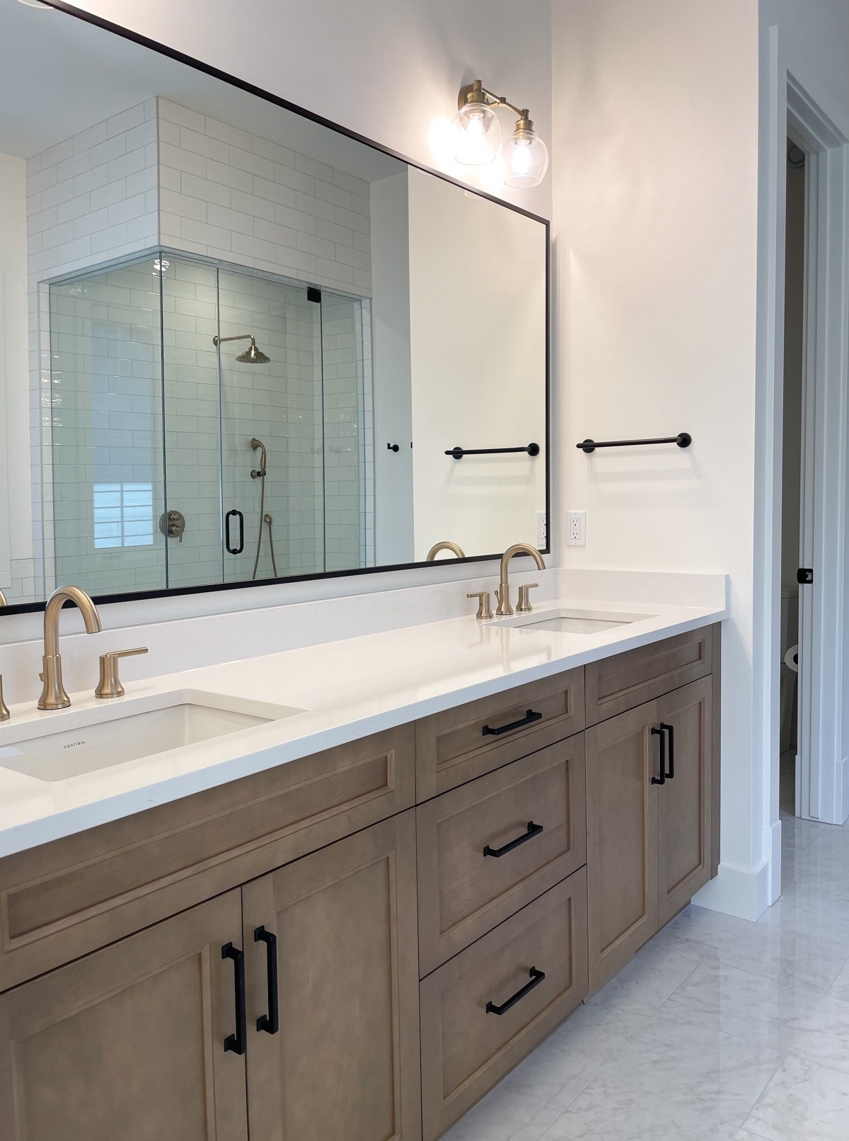 The finishes we chose for our primary bathroom vanity area: aged brass sconces, widespread faucets, and black cabinet pulls. Love the warmth they add to our bathroom. Some currently on sale!

See full room: https://satoridesignforliving.com/our-primary-bathroom-what-wed-do-differently-and-what-wed-keep/

#LTKSaleAlert #LTKHome