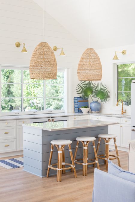Our Omaha pool house kitchen featuring woven basket pendant lights, white backless counter stools, and blue striped rug, faux fan palms in a blue vase, and gold sconce lights and kitchen faucet.
.
#ltkhome #ltksalealert #ltkstyletip #ltkseasonal #ltkunder50 #ltkunder100 #ltkfind kitchen counter stools, bar stools, coastal decorating ideas, kitchen pendant lights

#LTKhome #LTKSeasonal #LTKsalealert