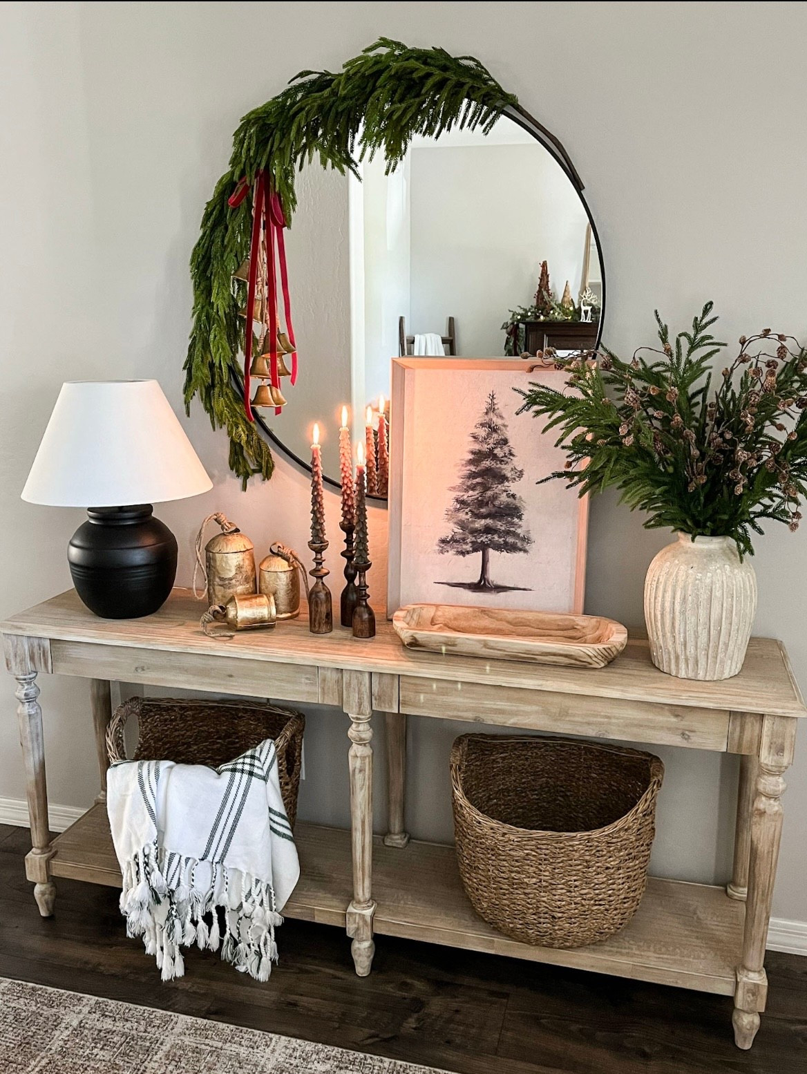 Christmas entryway console! Follow @lifeinmyarizonahome on Instagram for more holiday ideas and inspiration.
For reference I'm using 4
Norfolk stems and 4
snowy pine cone stems.

Everett Long Weathered
Natural Wood Foyer Table | Christmas tree art | gold cow bells | table lamp | wood candlesticks |
Christmas tree candles I wood dough bowl!
Weathered Handcrafted
Terracotta Vase | woven baskets | plaid throw blanket | 36 in round black mirror | Norfolk stems | pine cone stems | hanging gold bells | red velvet ribbon Norfolk 5ft
garland

#christmasdecor #homedecor #holidaydecor

#LTKHoliday #LTKSeasonal #LTKHome