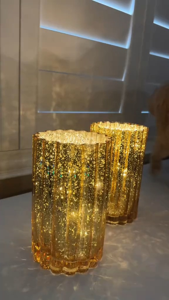 These hurricanes do more than light up a room; they enhance the entire atmosphere with a design that's both classic and innovative. The mercury glass has a ribbed exterior that beautifully reflects light, paired with a high-shine interior that radiates a captivating glow. Each set comes with a removable 15-micro-light strand, providing a soft illumination that's adjustable between twinkle and steady modes. Plus, the built-in six-hour on/18-hour off timer makes these hurricanes as practical as they are pretty. Whether you're hosting a dinner party or just enjoying a quiet night in, these pieces promise to enhance your decor with just a flick of a switch.

 

 #LTKHoliday #LTKHome #LTKFindsUnder100