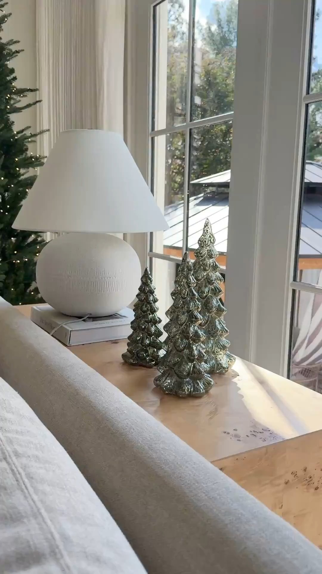 Simple sofa table styling for Christmas. A lamp, set of mercury glass Christmas trees! A set of large brass bells would love beautiful too 

#LTKHome #LTKHoliday #LTKSeasonal