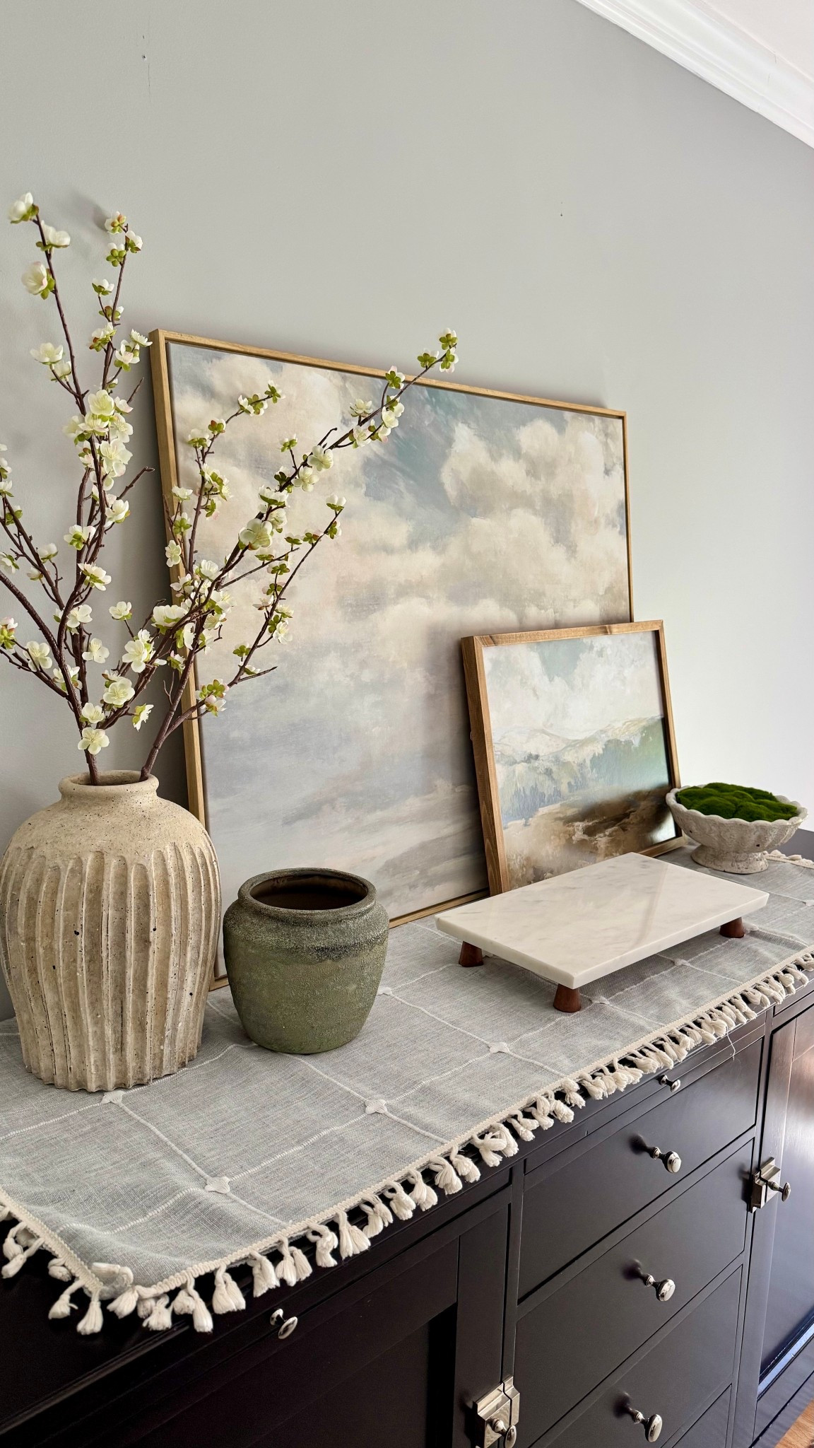 Sideboard styling in the dining room. Layered artwork, mix stone and marble accents make it feel collected.

Console table | sideboard | dining room decor| dining room | vases | wallart | blue decor | serving tray

#LTKHome #LTKSeasonal