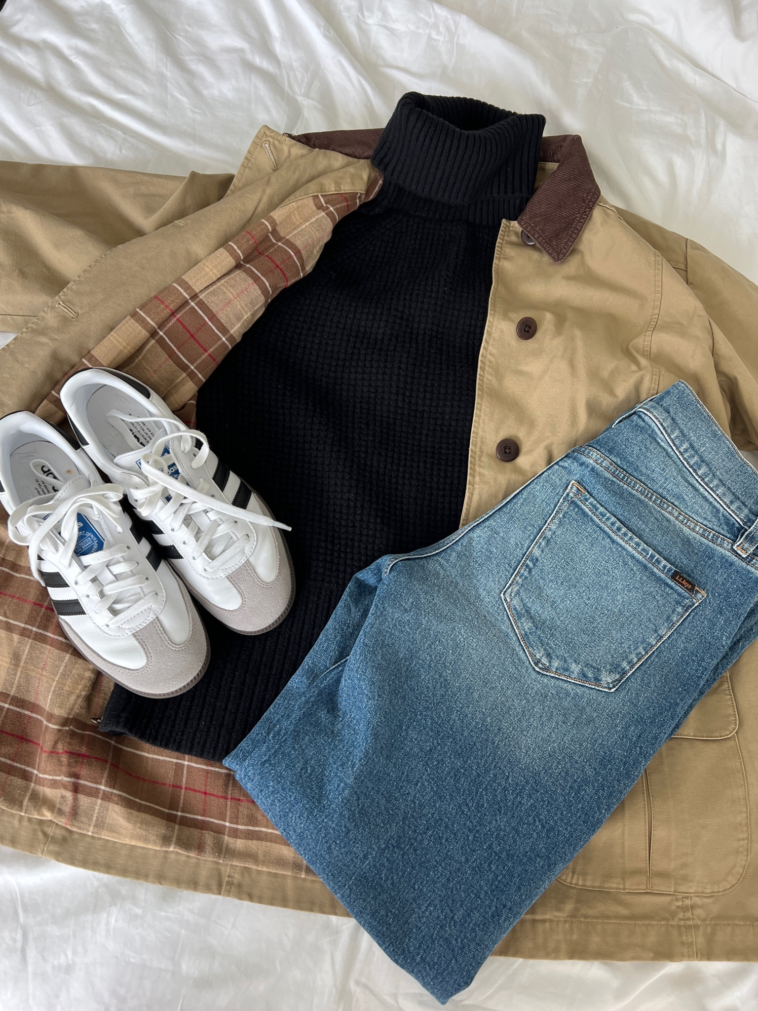 Fall outfit flat lay with adidas sambas, black turtleneck, jeans, and L.L. Bean barn coat 