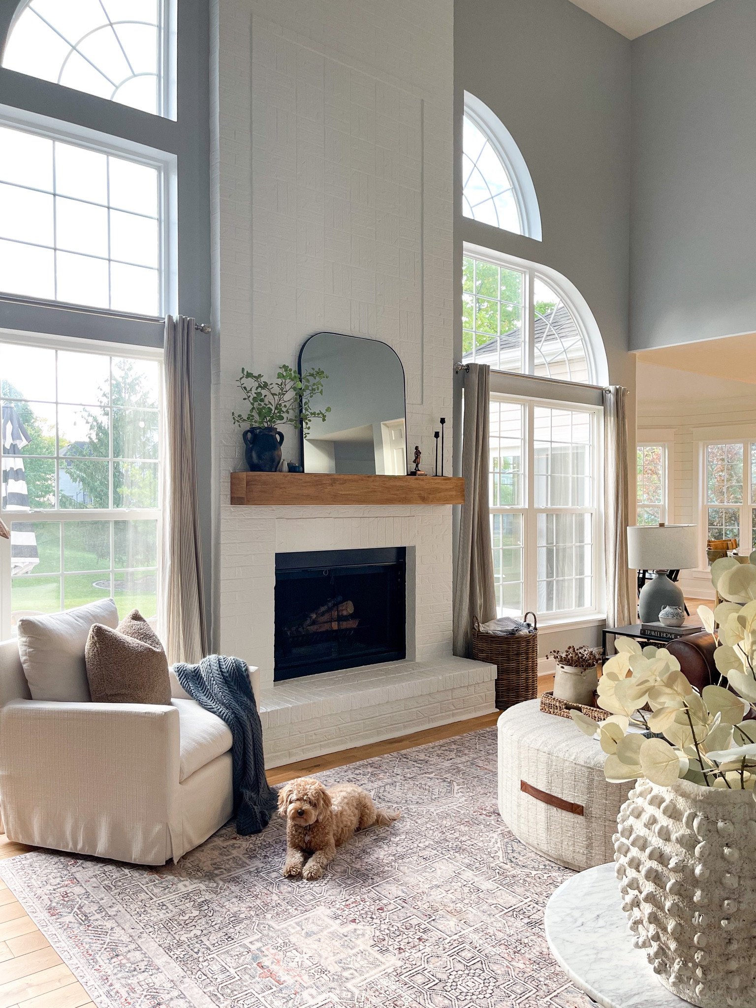 Family room, round ottoman, McGee & Co., Studio McGee, Pottery Barn, Loloi rugs, fireplace, mantel, Anthropologie, arched mirror, leather sectional, cozy, neutral decor, home decor, home style 

#LTKsalealert #LTKSeasonal #LTKhome