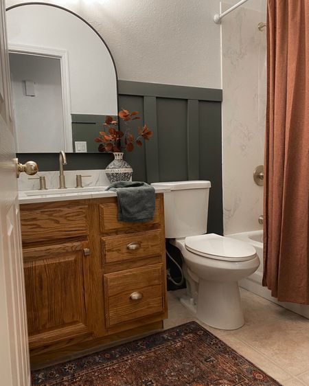 Bathroom decor. Moody decor. Small bathroom. Wood cabinets. 

#LTKFind #LTKSeasonal #LTKhome