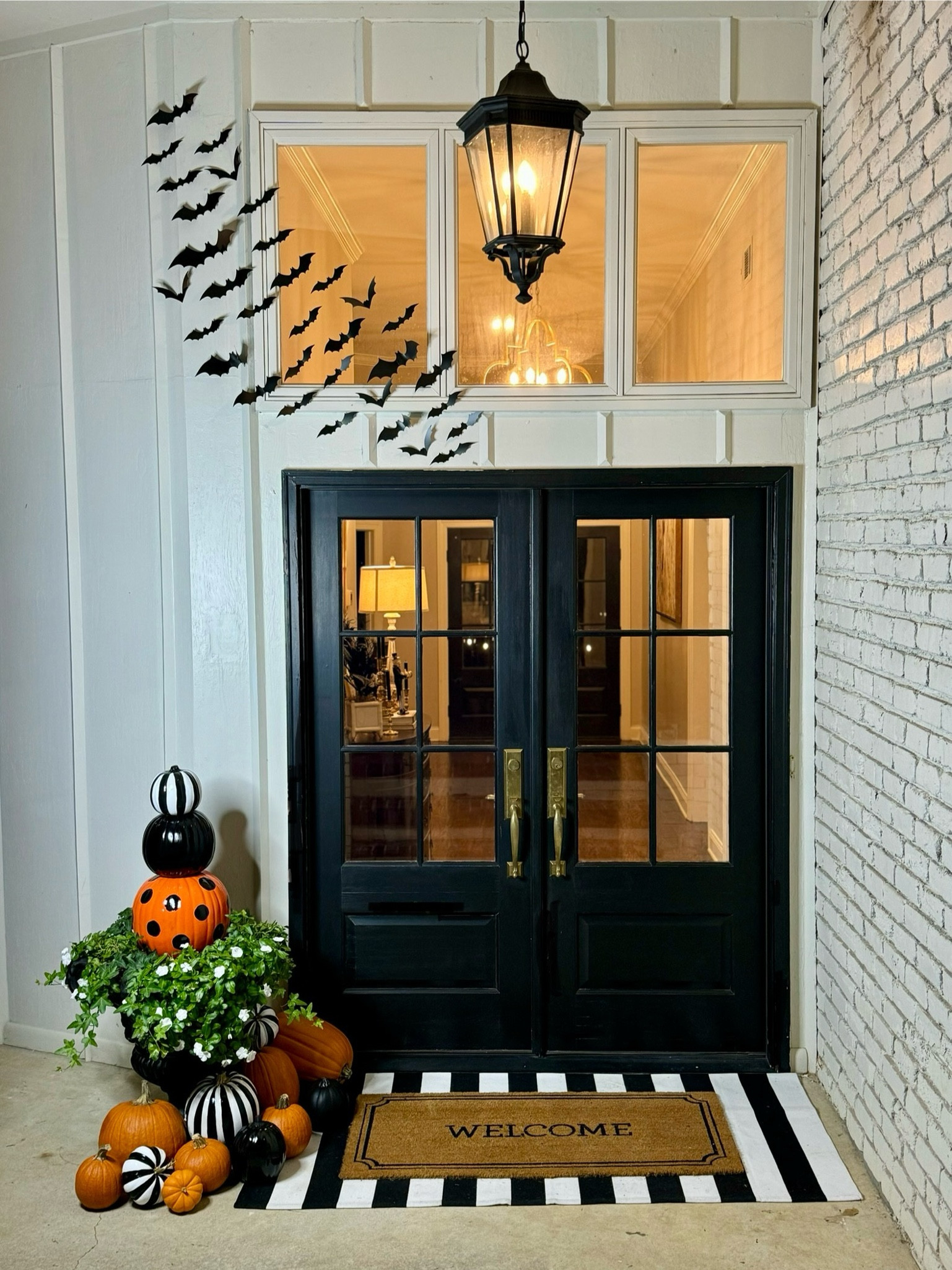 Halloween front porch decor 
Flying bats, painted pumpkins, painted stacked pumpkins, black and white mat, welcome mat 

#LTKHome #LTKSeasonal #LTKHalloween