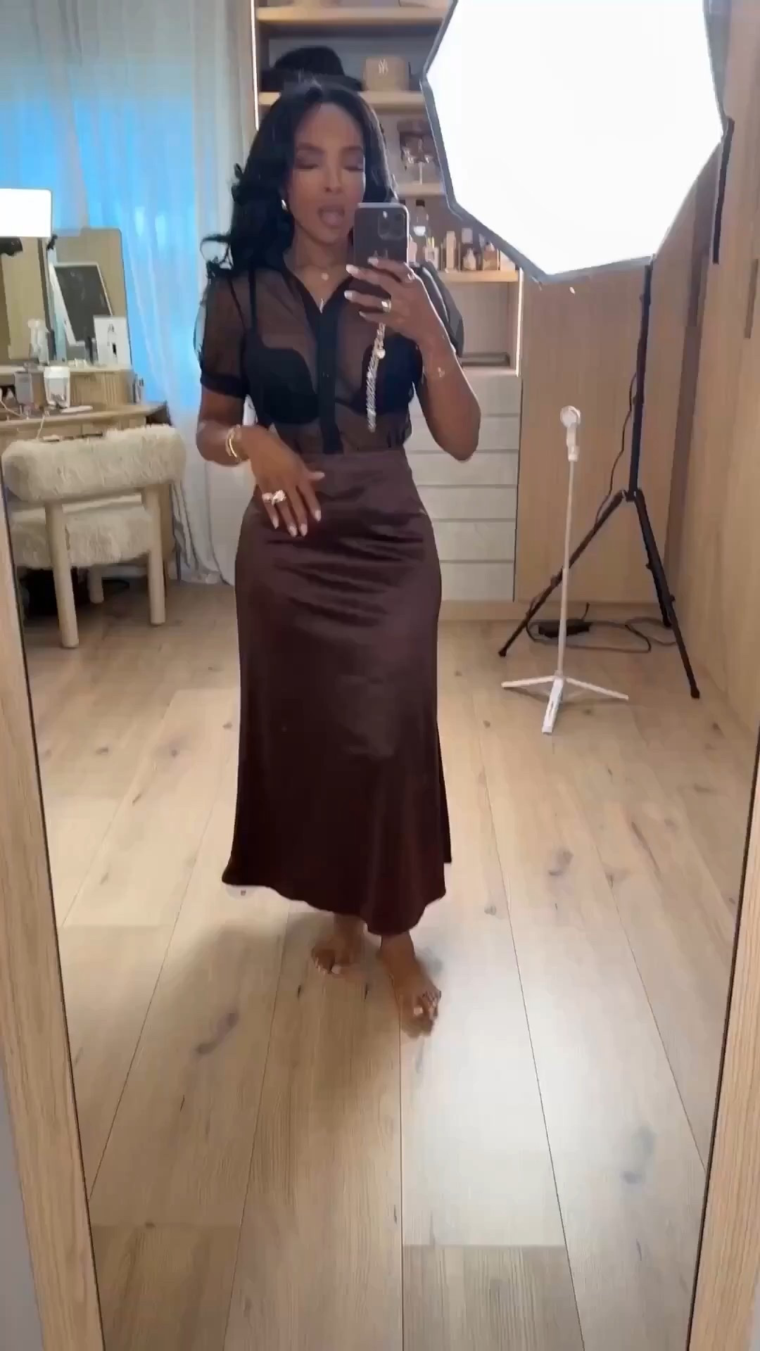 This satin skirt moment is pure elegance with an edge. The fluid drape paired with a sheer top gives that effortlessly dressed-up vibe that works for both nights out and elevated dinners.

One of those pieces that styles endlessly — swap the top, add a blazer, or dress it down with flats and the cost per wear keeps dropping. A true long-term closet staple.

Perfect for date nights, birthday dinners, cocktail events, girls’ night out, or vacation evenings.

📏 Sizing & Fit  
Top: Size Small  
Skirt: Size Small  

📐 Measurements  
Height: 5'4"  
Weight: 138 lbs  
Bust: 34D  
Waist: 27"  
Hips: 40"  

Save this post to revisit later or tap to get details.

satin midi skirt outfit, sheer top styling, elevated date night look, chic dinner outfit, luxury look for less, versatile evening wear

Follow me on Instagram and YouTube @kirasfashionfinds 

#LTKPetite #LTKootd