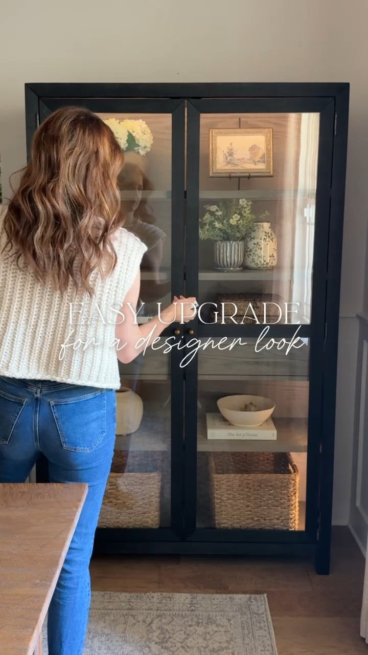 Loving how this Amazon find elevated and added warmth to my little black display cabinet! 😍 It comes with a remote control and is also dimmable. You just peel the tape off and stick it on! I also installed one behind our bedroom full length mirror a year ago. 

I just drilled a small hole in the bottom corner of the cabinet so the cord could slip through and be plugged in behind the cabinet.

#LTKFindsUnder50 #LTKHome #LTKFindsUnder100