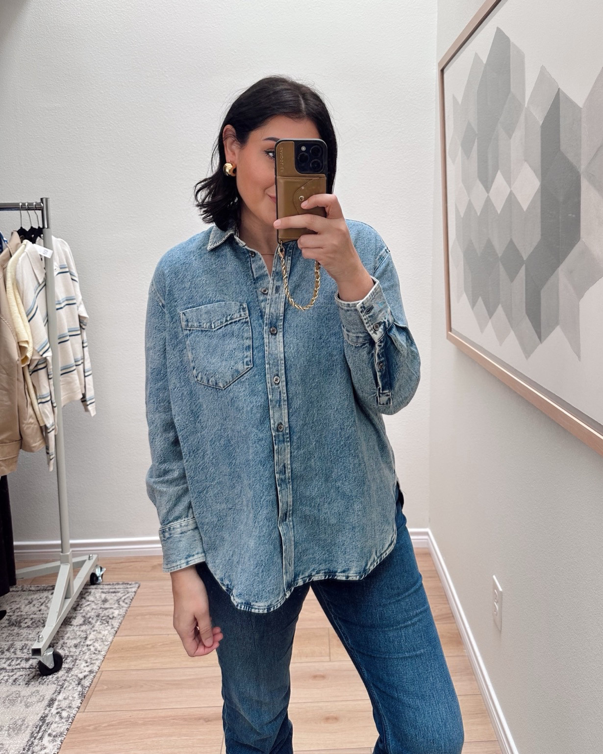This top is like a mix between a denim jacket and a chambray shirt. It’s not as strucutred as a denim jacket, but it’s not as soft as a chambray shirt. I like it for a shacket function, as well as an oversized button down shirt. 

I’m in the medium, fit is oversized but true to size.

I'm in the 30 of the jeans! 

 