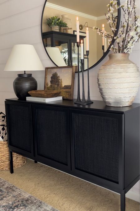 Sideboard Styling. Follow @farmtotablecreations on Instagram for more inspiration. Sideboard Decor. Dining Room Console. Target Threshold Lamp. Moody Artwork. Candlesticks. Artisian Vase. Spring Blossom Stems. Coffee Table Books. Pottery Barn Vase  