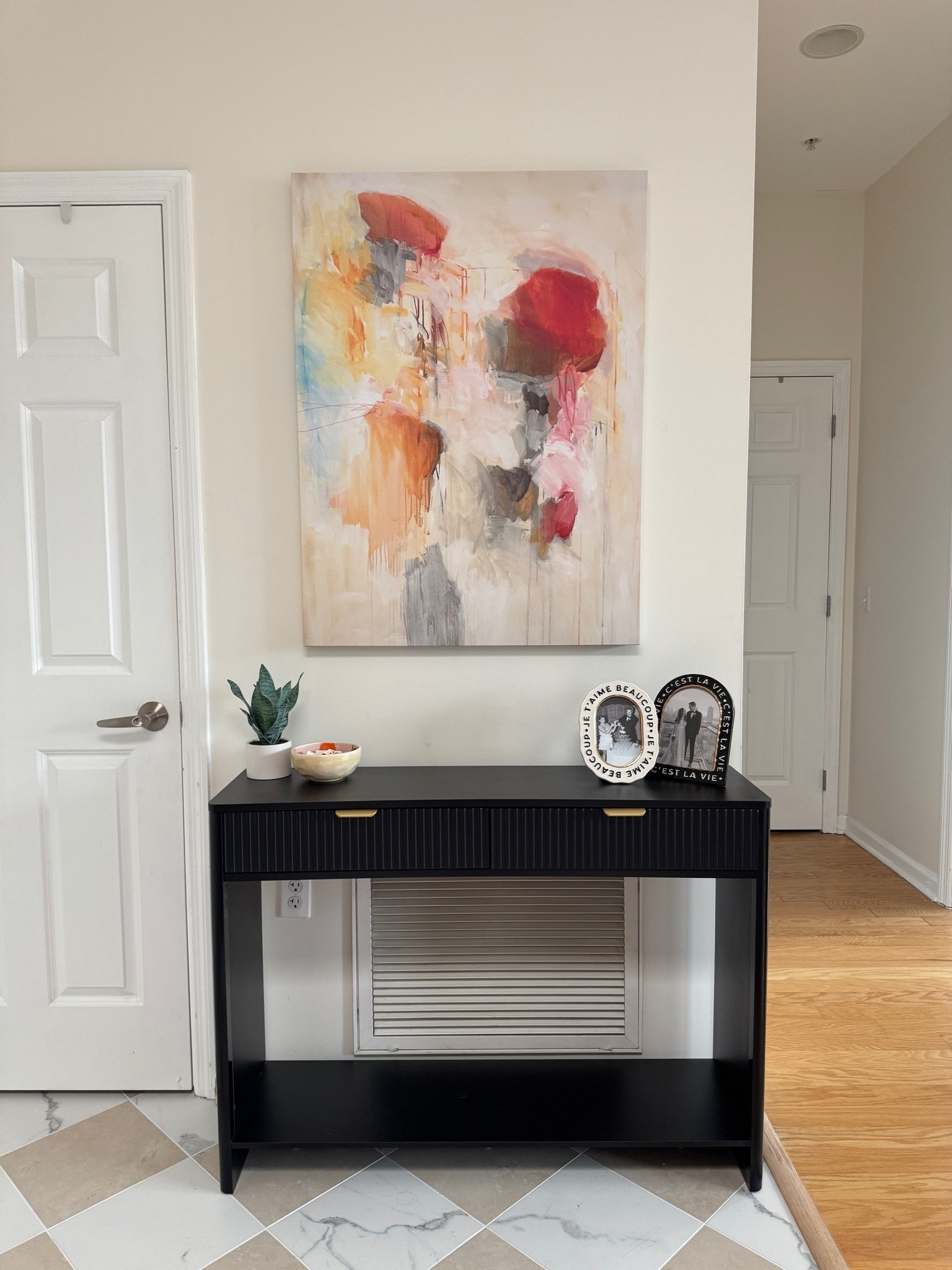 Our entryway! This gorgeous console table hides the vent and the canvas wall art adds color to the space.

#LTKHome