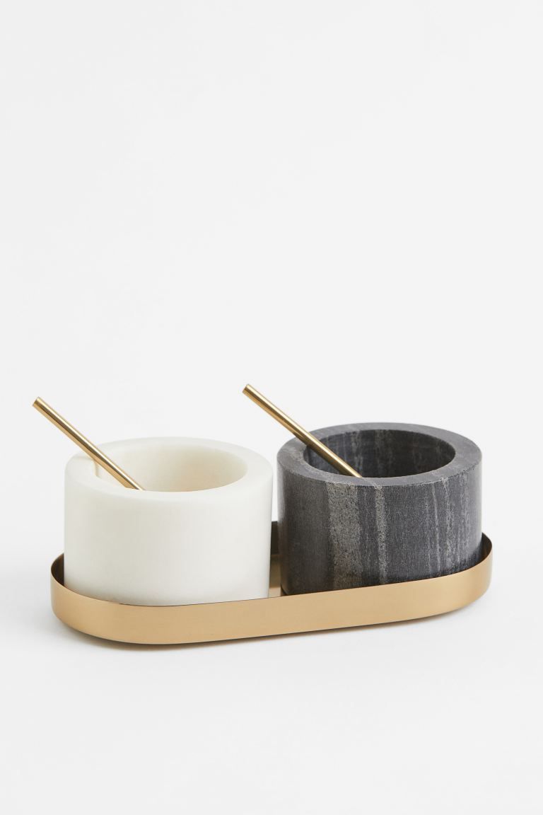 Small marble bowls for salt and pepper with an oval tray in metal. Each bowl with serving spoon. ... | H&M (US)