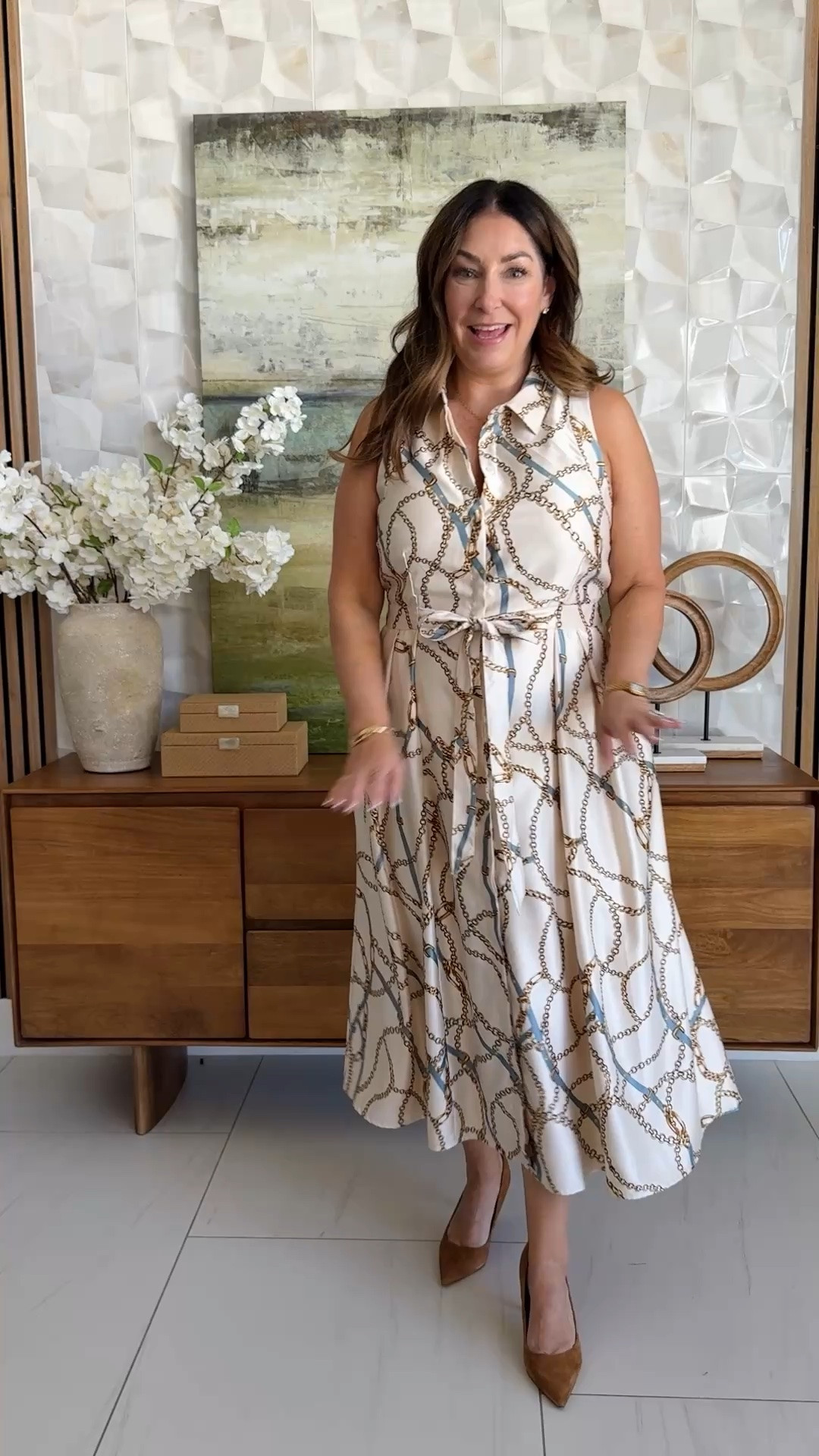 Champagne cream sleeveless midi shirt dress in a gold chainlink print with a tie waist and pockets, styled with a cognac tote and brown suede pumps. An elevated workwear dress for early fall.

Sizing: true to size, large

#LTKSeasonal #LTKOver40 #LTKWorkwear