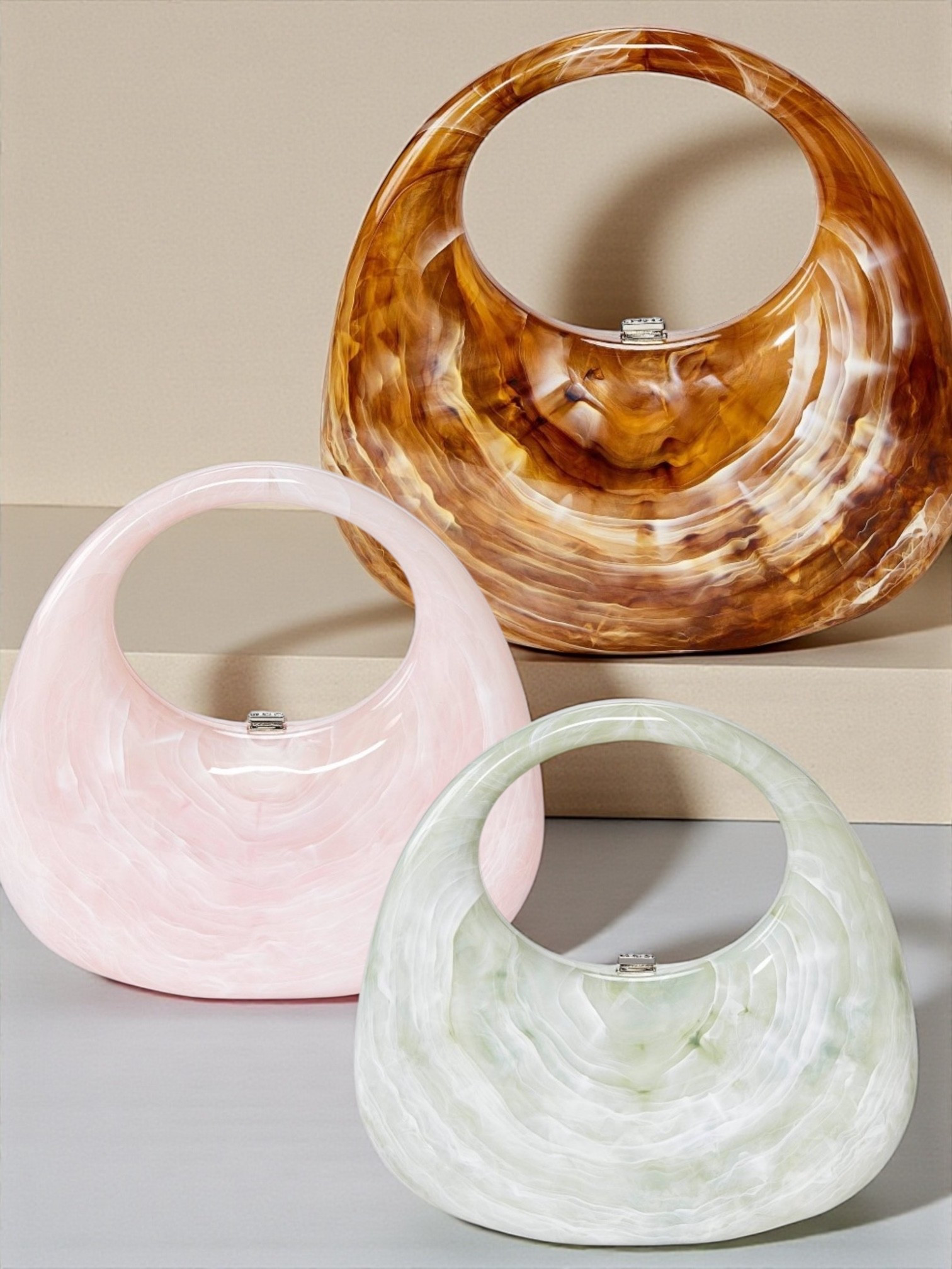 The perfect accessory! Crescent-shape minaudiere clutch.
• Crafted from acrylic shell
• Clasp closure
• Top carrying handle

#LTKU #LTKFindsUnder50 #LTKWorkwear