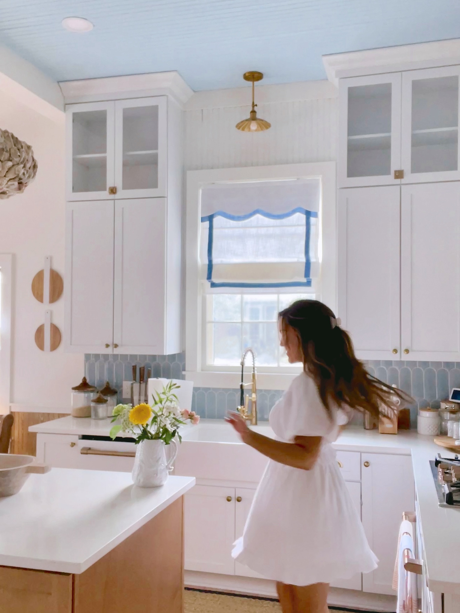 Coastal kitchen with scallop Roman shades and kitchen backsplash / white kitchen / beach house / grandmillennial home decor / coastal decor

#LTKHome