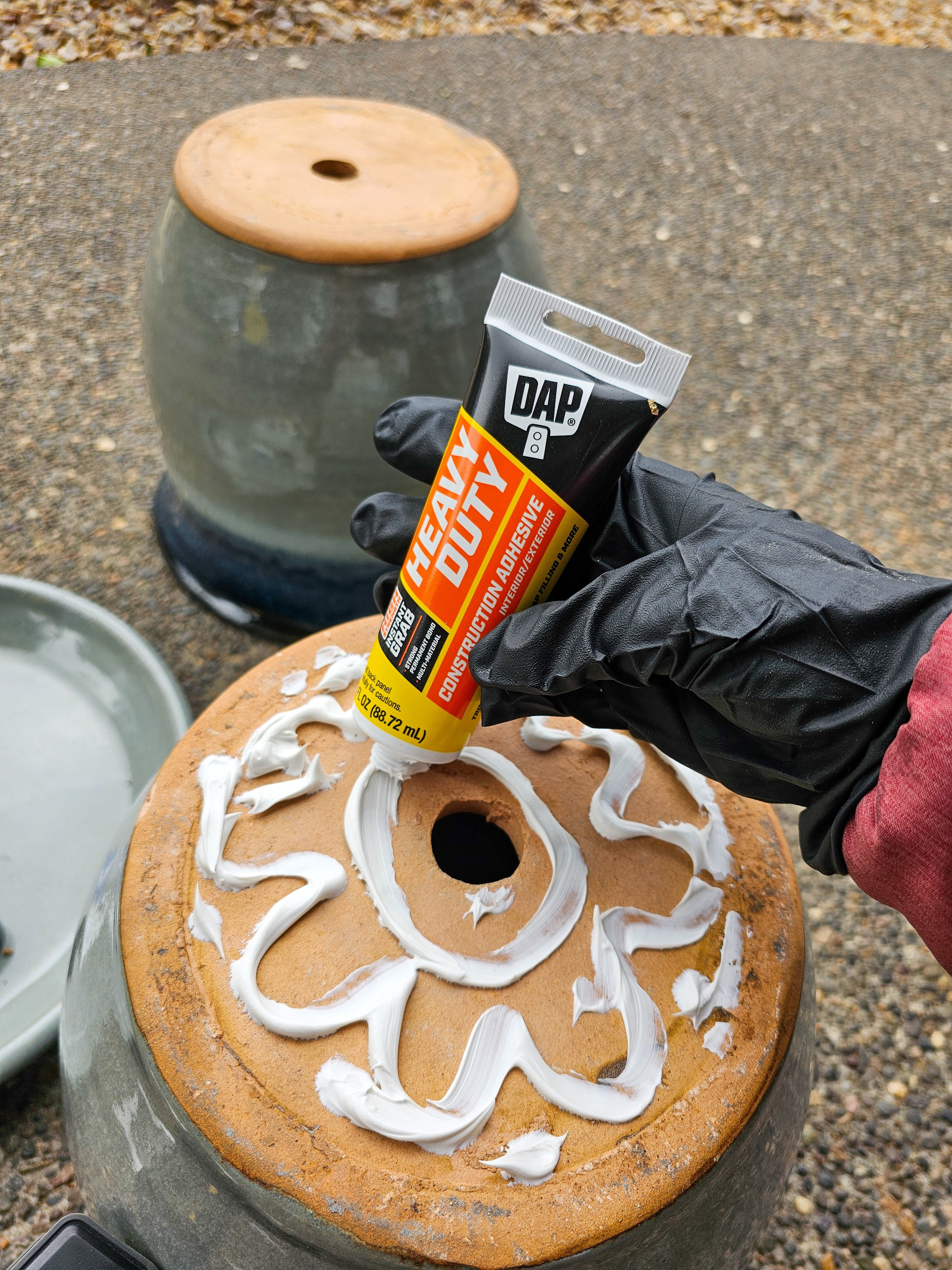 This DIY patio table is such an easy project! Just glue the bottoms of two planters together with heavy duty construction adhesive and add a tray to the top and voila! You've got a fun side table for the backyard that has storage inside as well! #diy  

 #LTKSeasonal #LTKHome