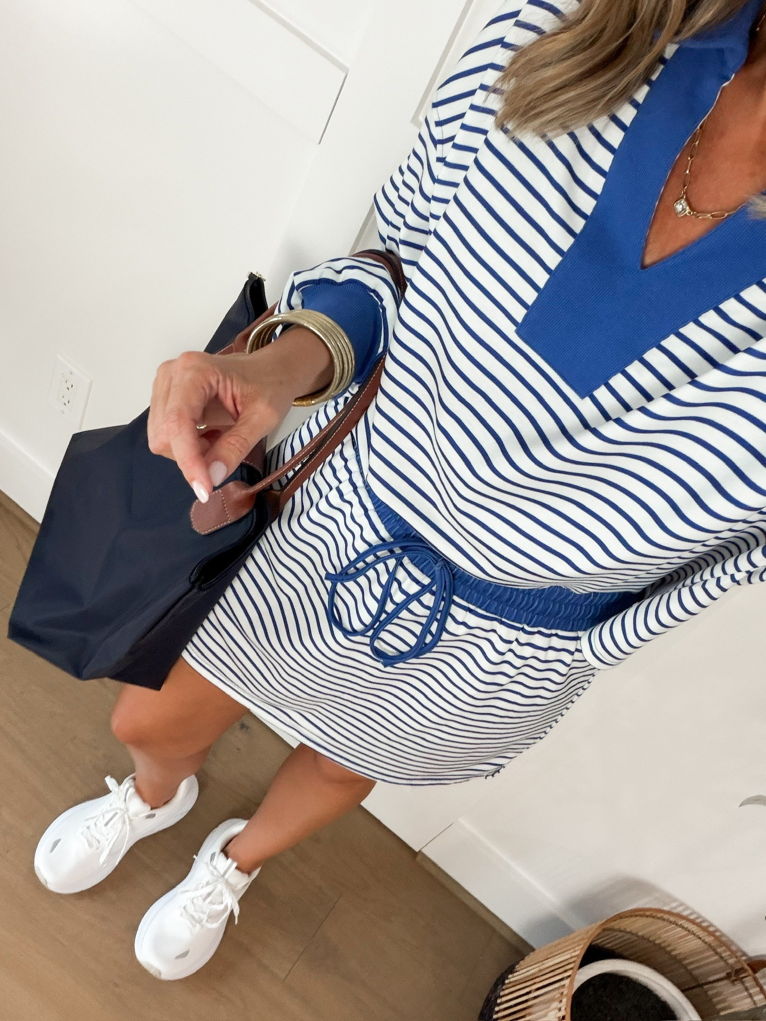 I love a matching set that makes getting dressed this easy! The blue and white stripes, contrasting blue trim, and relaxed fit give this set such a cute sporty look. Paired with white sneakers and a navy tote, it's a great outfit for running errands, casual weekends, or travel days.
blue striped matching set, blue and white striped set, striped shorts set, casual matching set, sporty outfit, two piece outfit, casual weekend outfit, travel outfit ideas, white sneakers outfit, comfortable casual style, women over 40 fashion, everyday outfit ideas, HauteandHumid