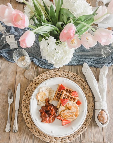 Easter table decor 🐰🌸 This spring table setting is perfect for Easter - I love the bunny napkin fold for Easter brunch. Just add fresh cut flowers to this simple spring place setting. 
.
.
Easter dinner table, farmhouse table, spring farmhouse dining room, placemat, white plates, white ceramic napkin rings, blue table runner, linen napkins

#LTKhome #LTKfindsunder50 #LTKSeasonal