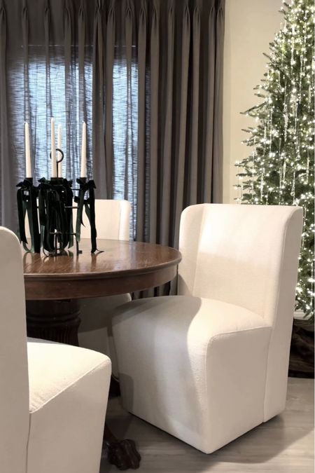 Modern to traditional dining room featuring white dining room chairs with rolling casters