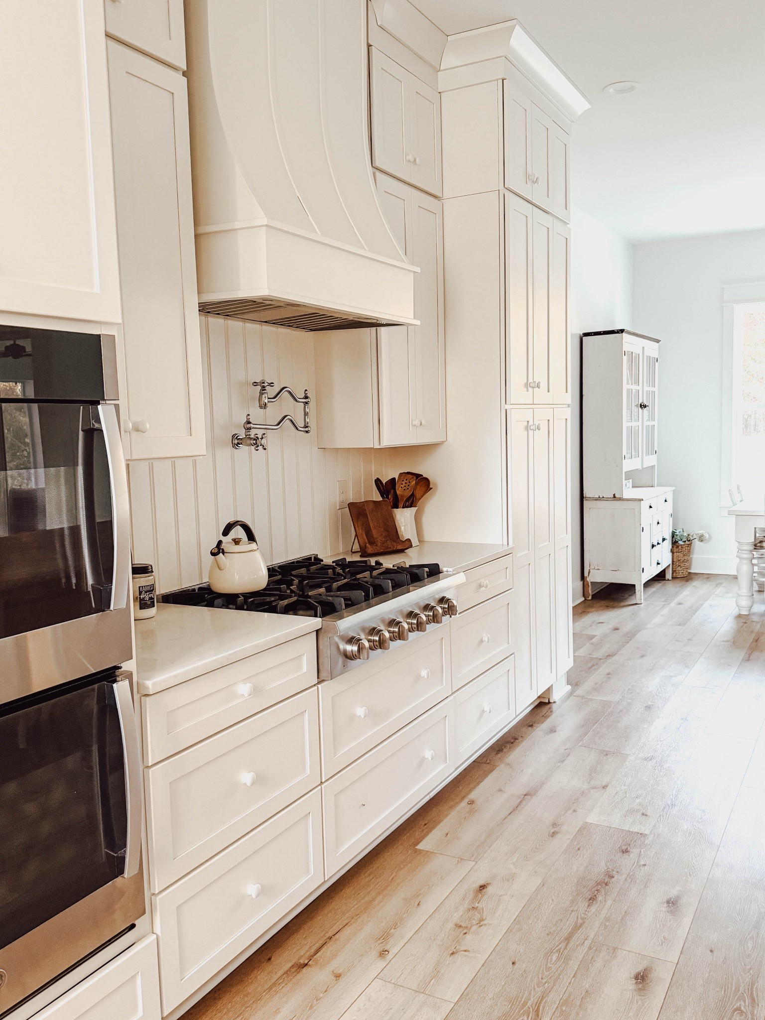 Cozy cream kitchen with wood accents. Magnolia kitchen utensils and pitcher, plus my favorite vintage pot filler in chrome. Farmhouse cottage style. 🖤

#LTKHome