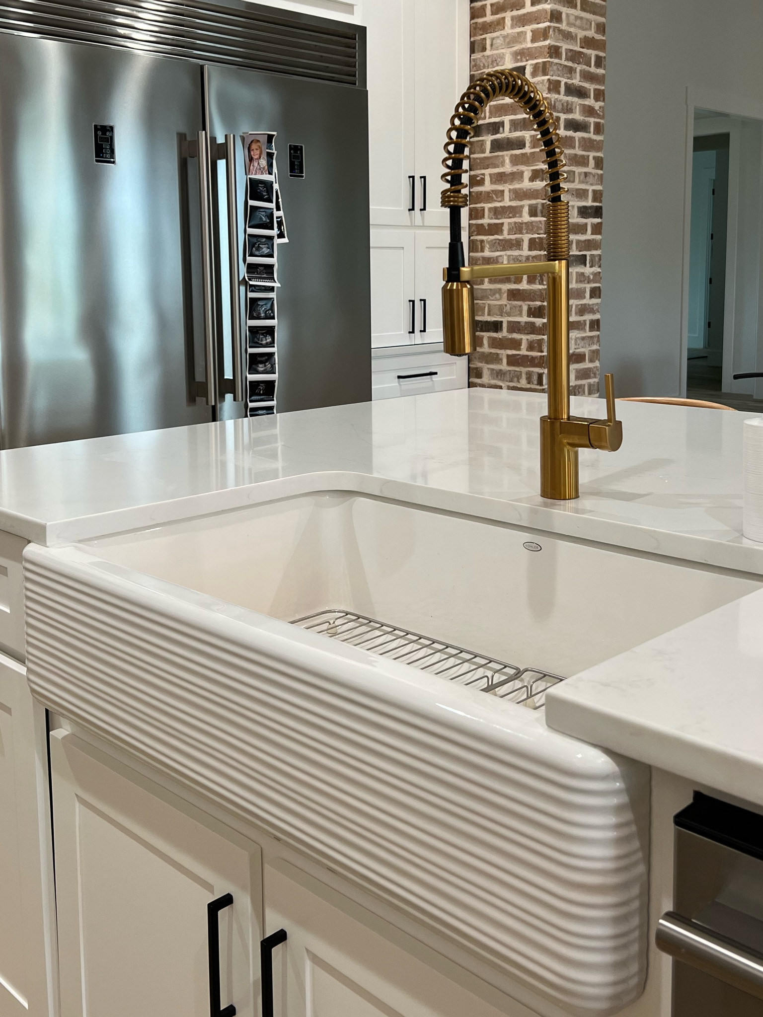 LOVE the white apron sinks. The detail on this one is so fun, can’t wait to give baby boy a bath here! This sink is from kohler! They make the best! Faucet is Moen. I wanted a spring faucet and the only one I could find in gold was from Moen! 

#LTKstyletip #LTKFind #LTKhome