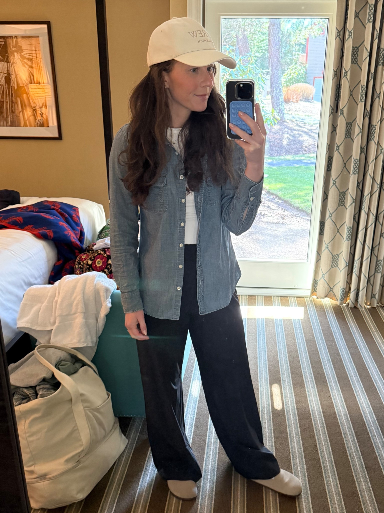 Travel outfit - cream baseball hat, chambray button down, white t-shirt, black white leg pull on pants from Beyond Yoga (my favorite!) with New Balance sneakers. 

#LTKTravel