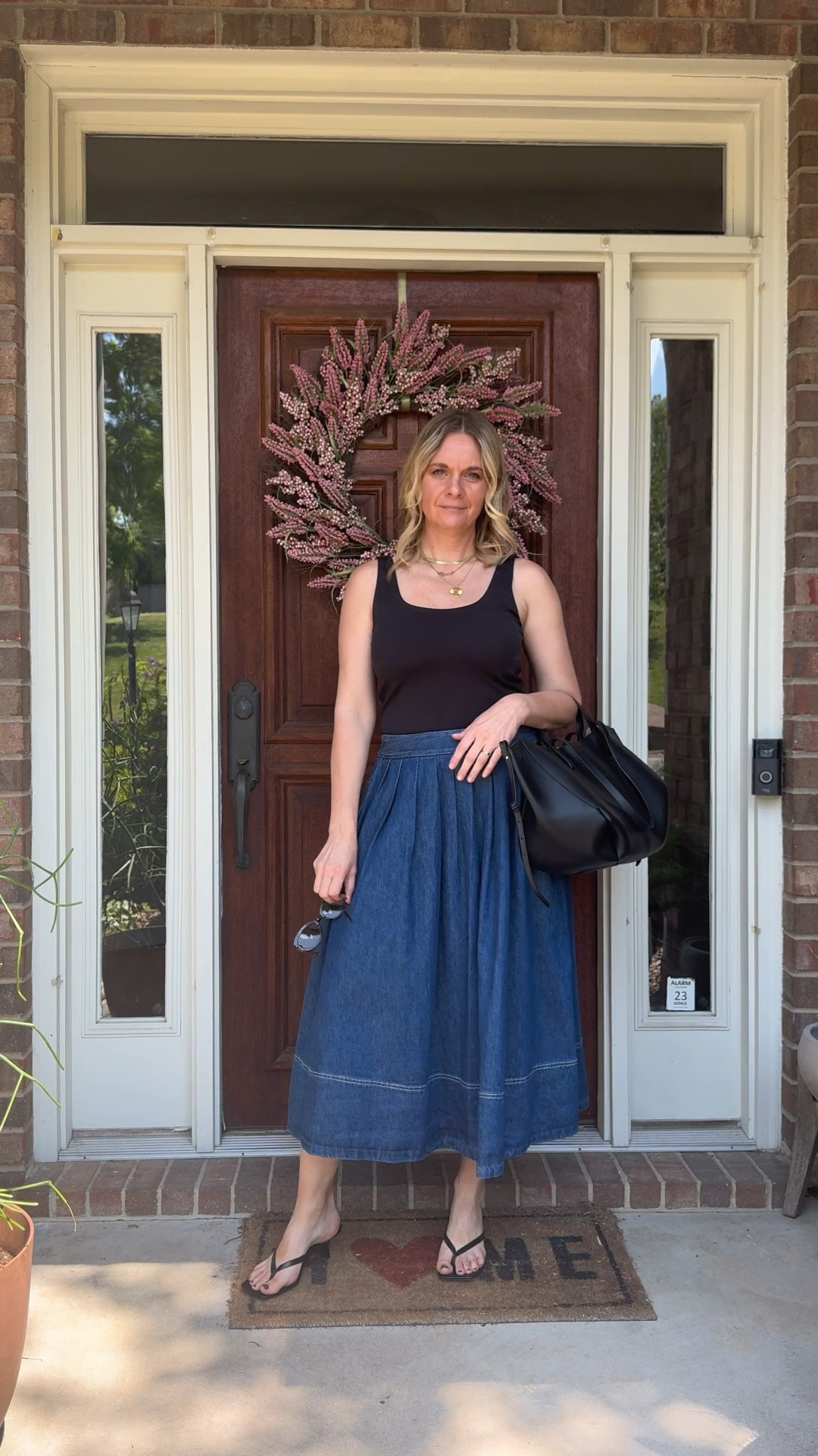 Here are 3 styling rules that make a denim midi skirt look sleek and modern — not costumey 👇

1) Keep the top sleek and fitted. A bodysuit or fitted tank tucked in eliminates bulk at the waist and lets the skirt be the focal point. The more relaxed the skirt, the more intentional the top needs to be. This is the rule that makes or breaks the whole look.

2) Let your shoes do the elevating. A kitten heel sandal, a loafer, or a pointed flat instantly modernizes a denim skirt in a way that a casual flat or sneaker just can't. Your shoe choice is what separates "effortlessly chic" from "accidentally casual."

3) Add one structured accessory. A great bag, a sleek pair of sunglasses, a gold necklace stack — one polished detail signals that you got dressed on purpose. It's the difference between a denim skirt that looks thrown together and one that looks completely intentional.

OOTD heading out for a personal shopping appointment with a client ✨ Black bodysuit + denim midi skirt + black thong kitten heel sandals. The skirt is new and still shoppable — linked it along with the rest of the look below! 👇

#LTKootd #LTKdayinmylife #LTKOver40