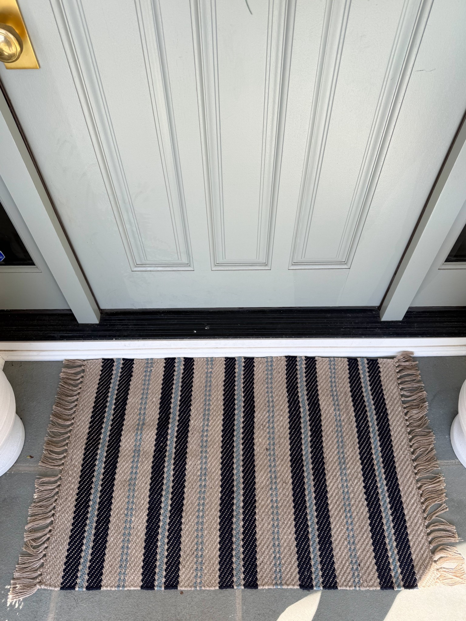 This striped rug is such a simple way to add pattern right at the entry without overwhelming the space. The neutral base with darker stripes keeps it classic, while the fringe detail adds just enough texture to make it feel a little more elevated. It’s one of those pieces that instantly makes a front door feel more styled and pulled together.

striped outdoor rug, front door rug ideas, entryway outdoor decor, neutral outdoor styling, front porch rug inspiration, classic entryway decor, layered outdoor decor, curb appeal ideas, outdoor entry styling, neutral exterior design, welcoming front entry girlonthehudson

#LTKHome #LTKSeasonal