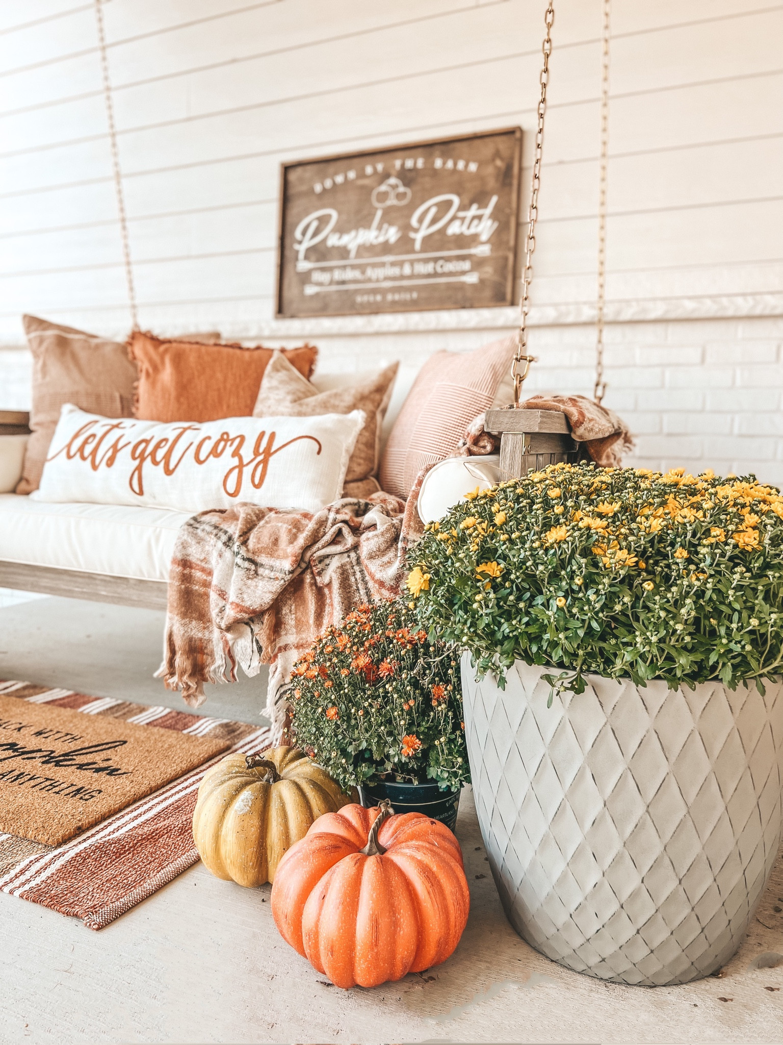 Shop my front porch. My porch swing is on sale right now! Kirkland pillows, Target pillows, fall front door mat, rug, throw blanket and pumpkins!

#LTKhome #LTKsalealert #LTKSeasonal