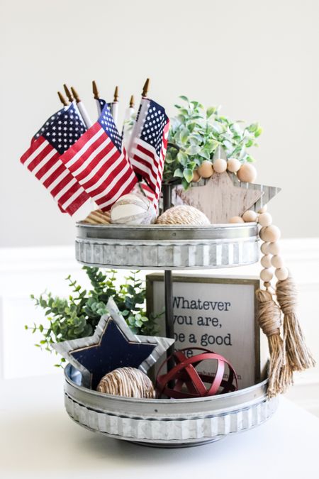 Decorate a festive patriotic tiered tray this summer! Proudly display these little American flags mixed with greenery and other neutral pieces. #patrioticdecor #tieredtraystyling #summerdecorating 

#LTKhome #LTKstyletip #LTKSeasonal