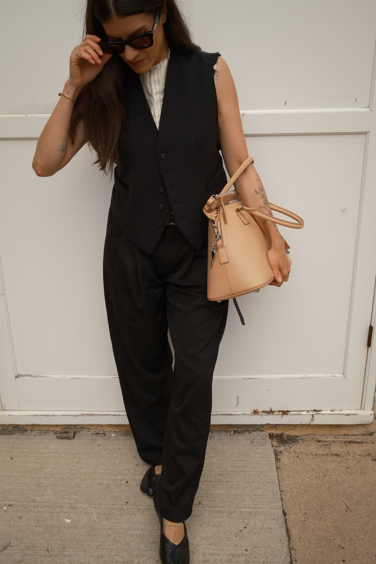 Pre-Fall Outfit Idea: A distressed Maison Margiela vest from the 2025 collection, styled with black trousers, Tabi ballet shoes and a 5AC bag.  

 #LTKsale #LTKstyletip #LTKbag