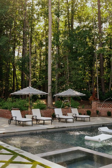 Our backyard pool and chaises! The outdoor striped umbrellas are game changers. Just got these pool floats and they’re so chic 🖤 

#LTKSeasonal #LTKhome #LTKFind