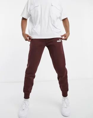 Puma Essentials logo sweatpants in dark brown | ASOS (Global)